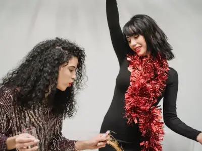 two girls are dancing on the new year eve party