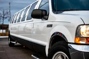 a white limo parked on the side of a road