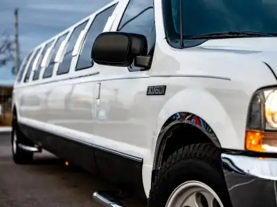 a white limo parked on the side of a road