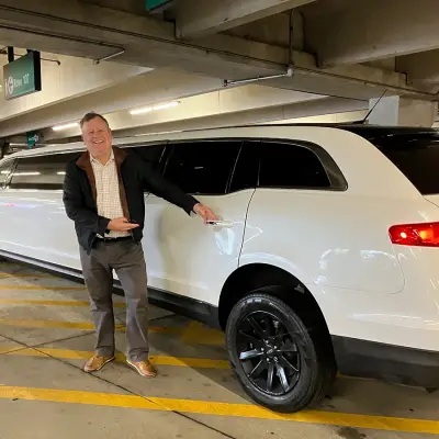 a driver stays near to the limousine